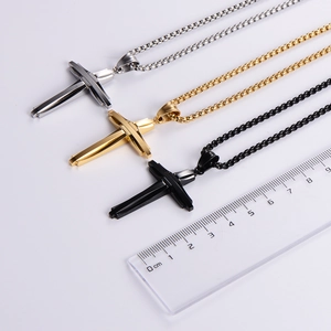 Three men's stainless steel cross necklaces in silver, gold, and black with a ruler guide