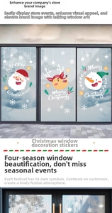 Detail of cartoon Santa and reindeer static stickers on a glass store window