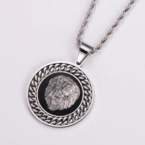 Macro detail of silver lion head pendant with textured chain border and twisted chain