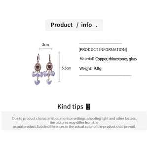 Detail view of purple crystal heart drop earrings showing size dimensions and materials