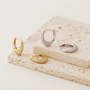 Close-up of S925 sterling silver hoop earrings with pave cubic zirconia on stone base