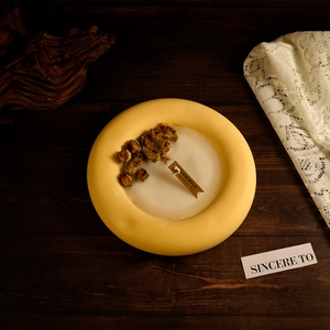 Macro detail of handmade circular resin tray featuring dried roses and wooden gift tag