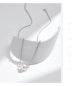 Detailed view of s925 sterling silver beaded chain with a round white pearl pendant