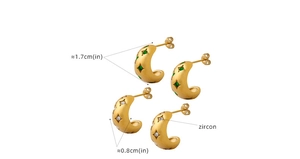 Detailed view of C-shaped matte gold hoop earrings with zircon and green gemstone inlays