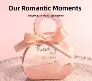 Detail of pink wedding candy box with satin bow and gold glitter on a glass tray