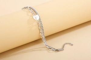 Detail of silver double-layered heart charm bracelet on a professional display