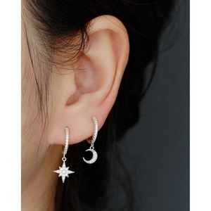 Close-up of S925 sterling silver moon and star earrings with sparkling rhinestones