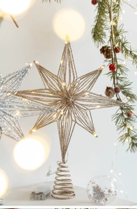 Close-up of golden iron Christmas tree topper star with LED lights and battery box
