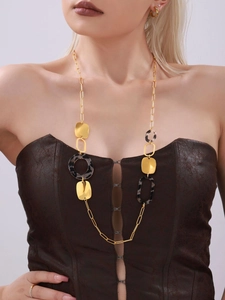 Detail of a 18K gold-plated long necklace with leopard print and geometric elements