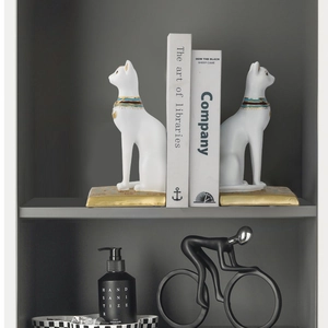 Pair of white Egyptian cat bookends with golden embossed details for home desk decor