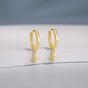 Detailed close-up of golden S925 sterling silver hoop earrings with star pendants
