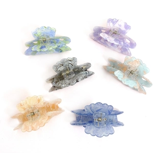 Set of six floral acrylic hair claws in assorted marble and gradient ocean colors