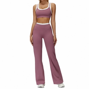 Two-piece dusky pink yoga set with sports bra and high-waisted flared leggings with white trim