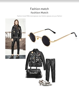 Steampunk round sunglasses styled with a black leather jacket and metal stud handbag