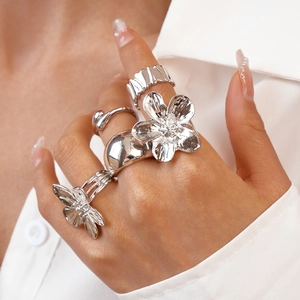 Silver geometric flower ring set with intricate 3D floral and abstract fluid designs