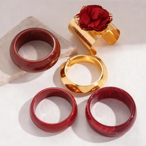 Retro resin geometric bangles set with a large red fabric flower and golden metal rings