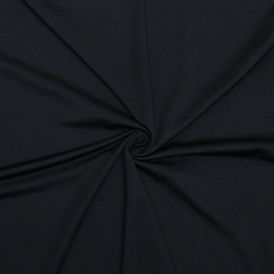 Close-up detail of black fabric texture with pleated design and elegant draping effect