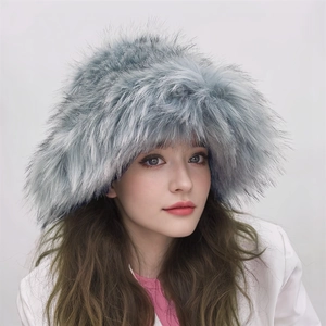 Close-up of light blue faux raccoon fur winter hat showing plush texture and warmth