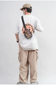 Rear view of transparent PVC crossbody bag with adjustable black strap on a model