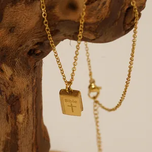 Golden stainless steel book pendant necklace with Bible engraving and cross on wooden branch