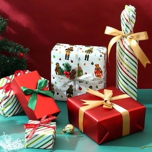 Christmas gift wrapping paper set with nutcracker prints and satin ribbons in red and green