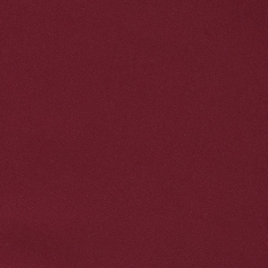 Macro close-up showing the fine texture and matte weave of the burgundy fabric dress