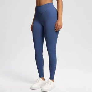 Detail of high-waist seamless yoga leggings in navy blue with peach lift effect