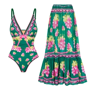 Detail view of deep V-neck one-piece swimsuit and matching high-waist maxi skirt set