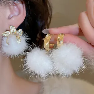 Winter floral earrings with white fluffy pom-poms and sparkling zircon flower accents
