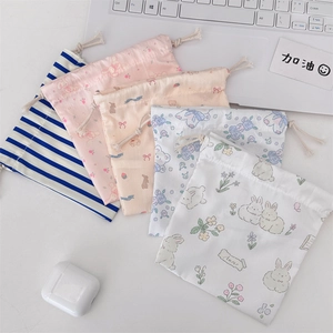 Close-up of five cute cartoon drawstring bags for makeup and gadget organization