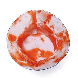 Orange and white tie-dye bucket hat with wide brim and reinforced stitching details