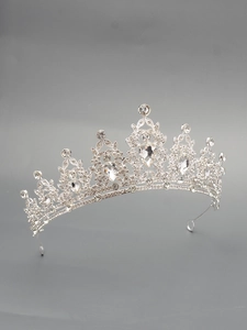 Close-up of vintage silver bridal crown with intricate rhinestone inlay and metal detail