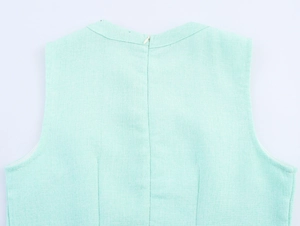 Close-up of mint green tweed dress back featuring invisible zipper and rich woven texture