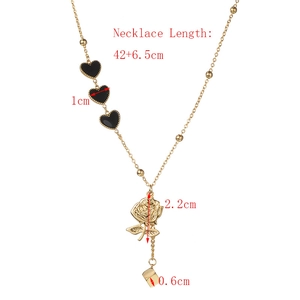 Detail of gold necklace with black heart charms and rose pendant including size labels
