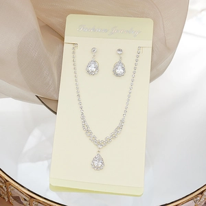 Detail of silver waterdrop jewelry set with sparkling rhinestones and matching earrings
