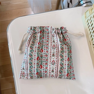 Detail of vintage oil painting style drawstring bag with red floral print and thick cotton rope