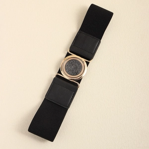 Elastic black waist belt for dresses with a round gold metal buckle and leather accents