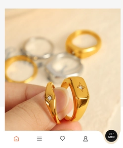 Close-up of gold plated stainless steel starburst rings with small zircon insets