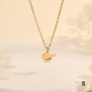 Detailed macro view of a golden bird pendant necklace with micro-pave cubic zirconia