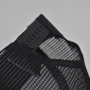 Close-up of adjustable snapback buckle and breathable mesh on black baseball cap