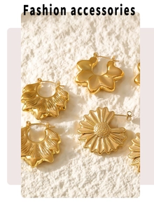 Detailed view of 18K gold plated hollow floral and wavy earrings on textured surface