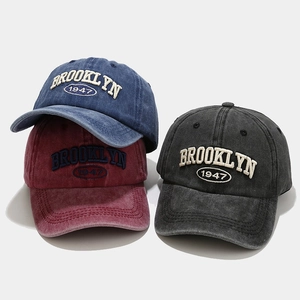 Detail view of washed cotton baseball caps with Brooklyn 1947 3D embroidery and vintage finish
