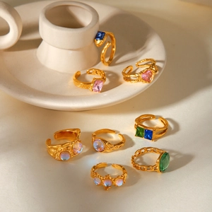 Detail view of vintage gold plated rings set with colorful zircons on ceramic holder