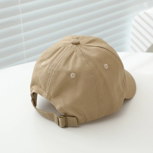 Detail of baby baseball cap featuring adjustable metal buckle and breathable eyelets