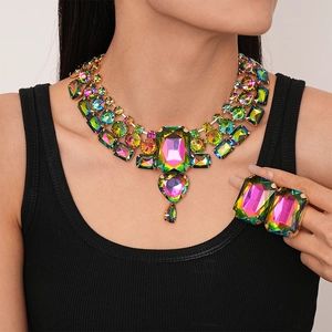 Exaggerated geometric necklace and ring set with colorful rhinestones on a model