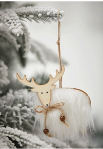 Macro shot of white plush wool reindeer ornament hanging on a snowy pine branch