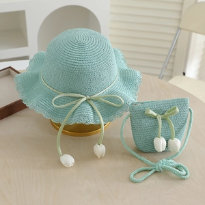 Detail of mint green straw hat and bag set with ribbon bow and tulip flower charms