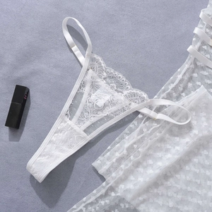 Macro shot of white heart polka dot lace fabric and scallop edge detail on lingerie