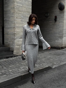 Detail of grey knitted two-piece set featuring texture on cardigan and slim maxi skirt