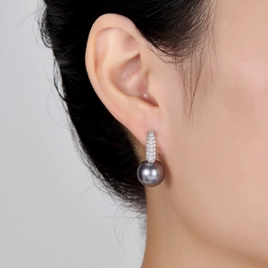 Close-up of elegant S925 silver earring with a grey pearl and micro-pave zircons